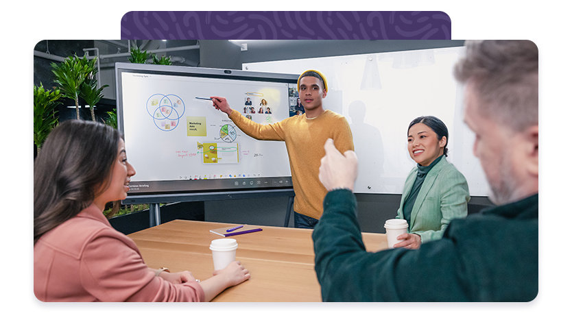 Group gathered in front of touchscreen having a discussion