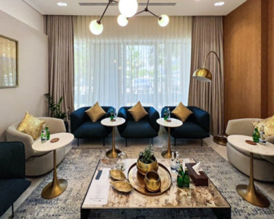 Casual seating in front of cream curtains with a brass center light