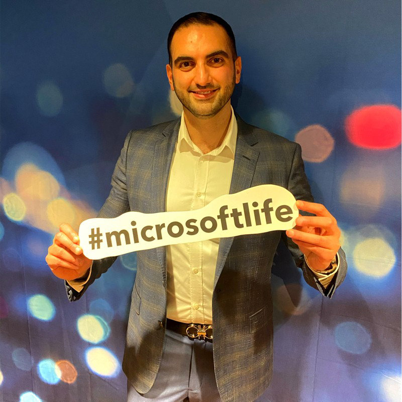 Sam Istephan holding a sign saying Microsoft Life