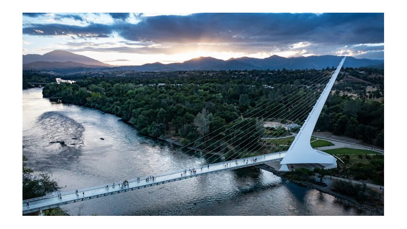 A pedestrian bridge spanning a river.