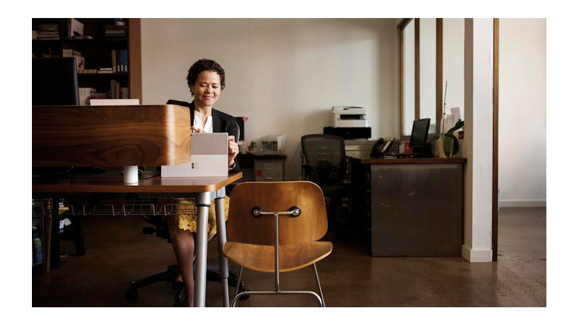 Business woman in office with Surface