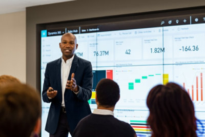 Man giving a presentation in front of room of people