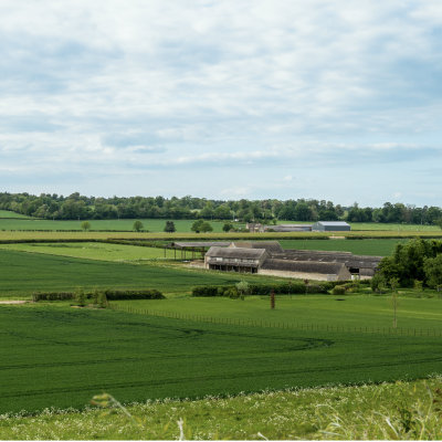 A farm surrounded by open fields.