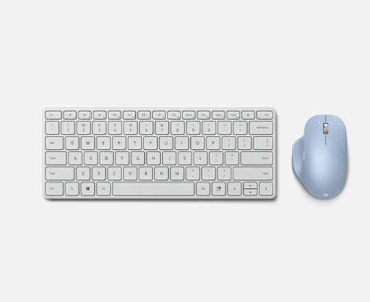 A Microsoft Designer Compact keyboard next to a Microsoft Bluetooth ergonomic mouse