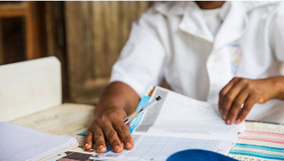 A medical worker goes through paperwork, including height measurement graphs, as part of a nutrition enhancement program in Madagascar.