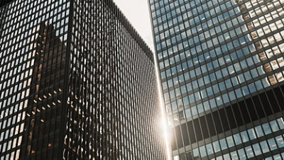 Exterior view of two skyscraper towers in a city setting.