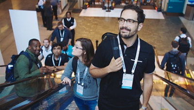A Microsoft employee rides the escalator up to a Microsoft conference event.