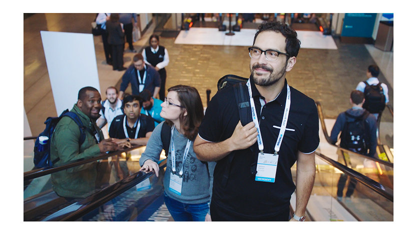 A Microsoft employee rides the escalator up to a Microsoft conference event.