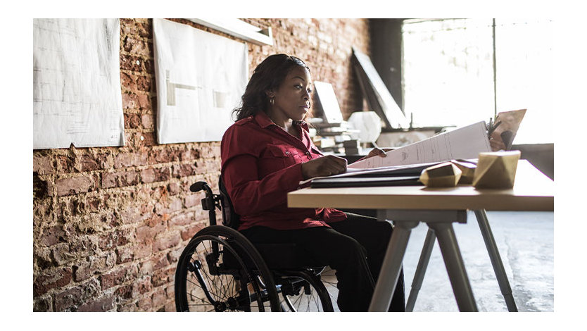 Woman in a wheelchair working at a desk