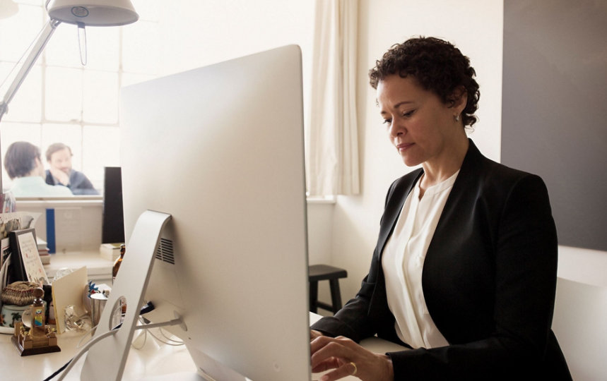 A woman works at a computer.