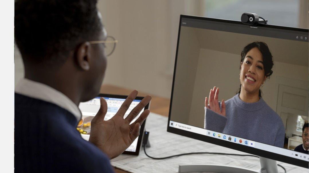 Man talking with business woman over video chat.