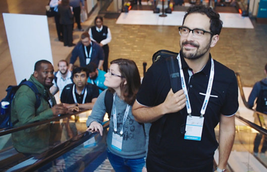 A Microsoft employee rides the escalator up to a Microsoft conference event.