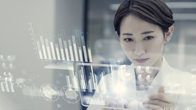 Female scientist looking at a futuristic display with data.