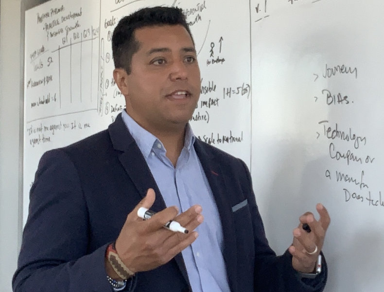 Luis Murgas of Wipfli talking in front of a whiteboard