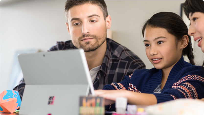 Man, woman, and child working on their computer