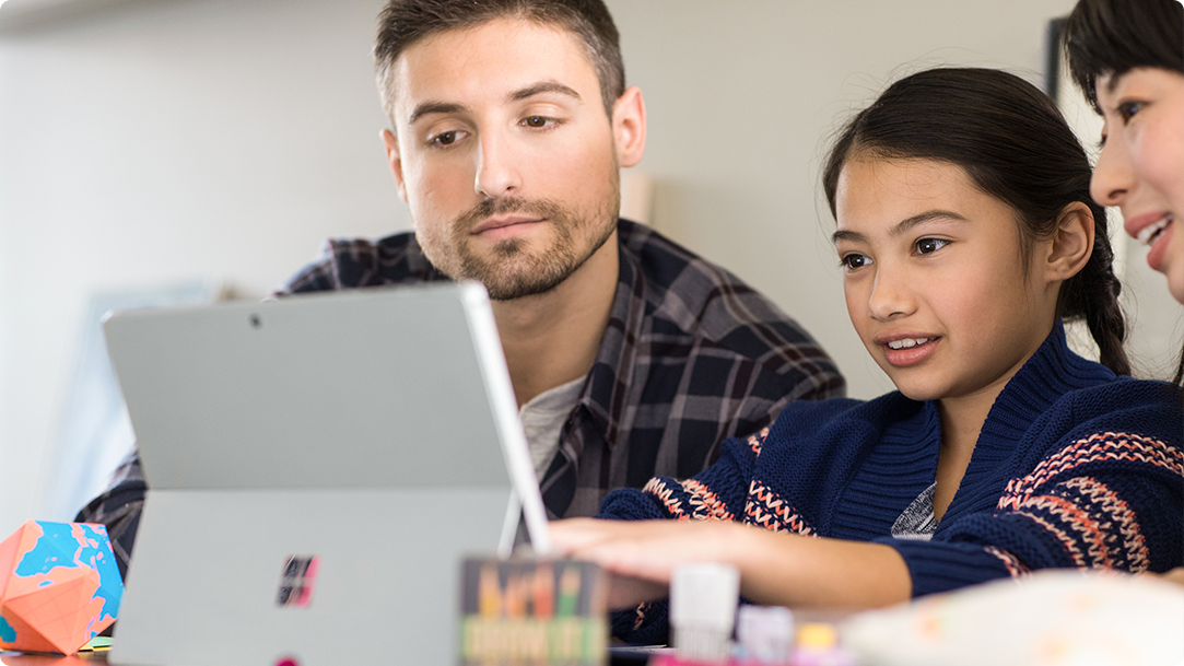 Man and child looking at a laptop with illustrated Christmas decorations