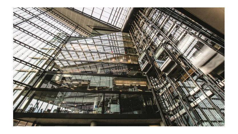 The inside of a Microsoft building looking up from the lobby at a series of offices and balconies. 