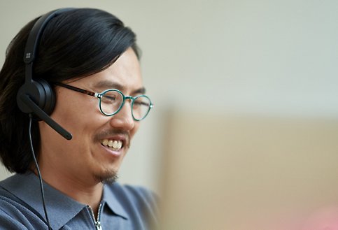 A person wearing a headset smiling