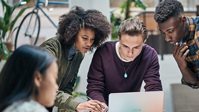 Group of people working together on a laptop.