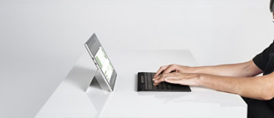 Digital devices displaying various data visualizations including bar charts, pie charts, and graphs against