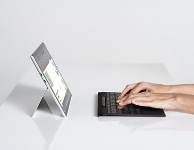 A tablet, smartphone, and laptop display various charts and graphs