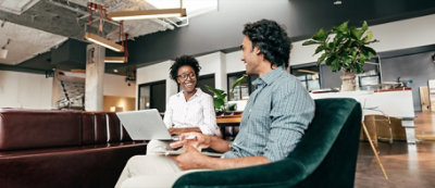 Man sitting and looking at his tablet.