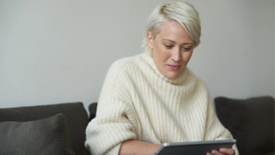 A women looking on tablet.