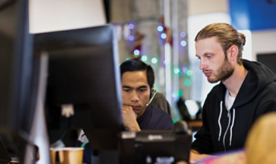 Two persons are looking pc.