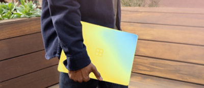 A person holding a laptop.