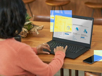 A person sitting at a table using a laptop.