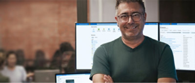 Un hombre con gafas sonriendo.