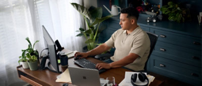 A person sitting at a desk using a computer.