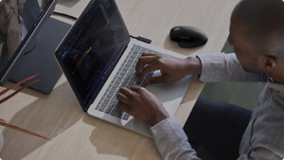 A top down view of a person typing on a laptop