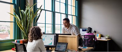 Two people sitting at a desk in an office - office stock videos & royalty-free footage.