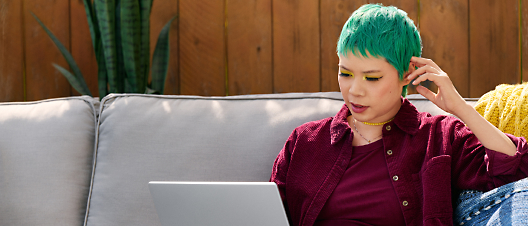 A person with green hair using a computer