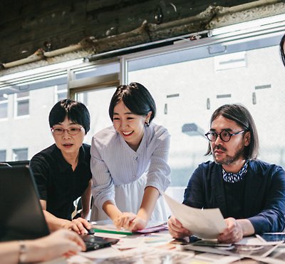 A group of people looking at papers
