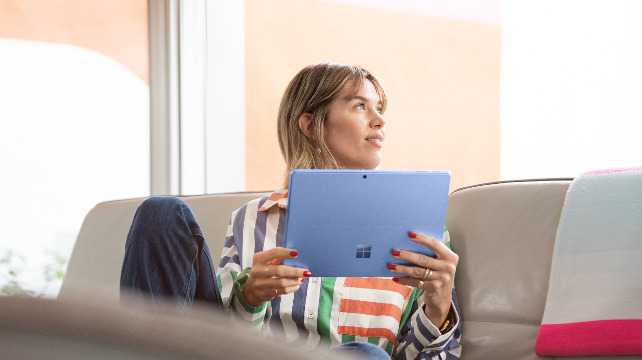 Woman holding Surface Pro 9