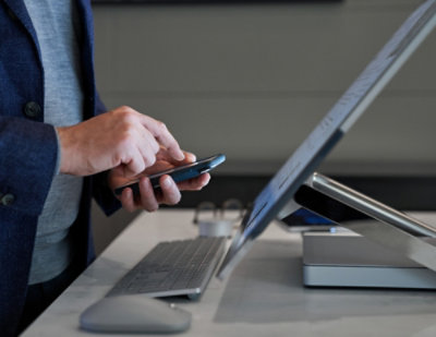 A person using a mobile device in hand