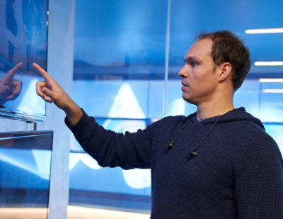 person interacting with large touchscreen display