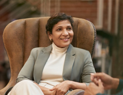 Professional conversation in a seated indoor setting.