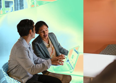 Two people working together on a laptop.