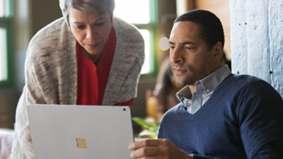 Colleagues reviewing content together on a laptop