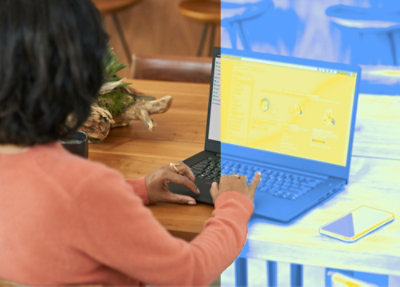 A woman typing on a laptop
