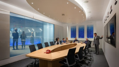 A woman walking and holding a tablet