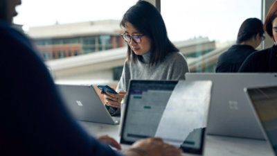 Person working on laptop in a modern office seating area