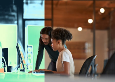 Two people looking at a computer screen.