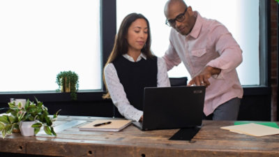 People working together reviewing something on laptop