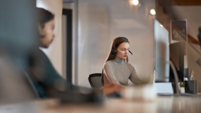 Person working at a desk with a computer in a modern office