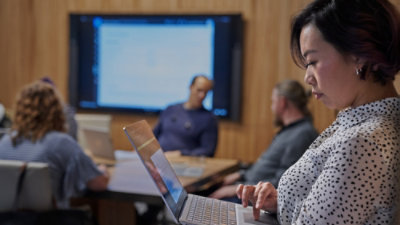 Woman using laptop in conference room