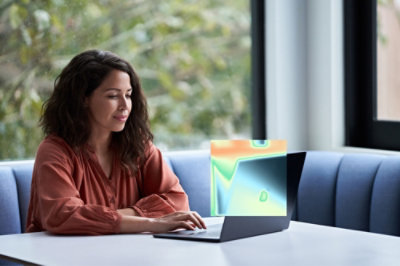 A person typing on a laptop at a table.